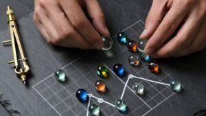Hands arranging colorful glass spheres to visualize analyzing probability patterns in Asian market lotteries